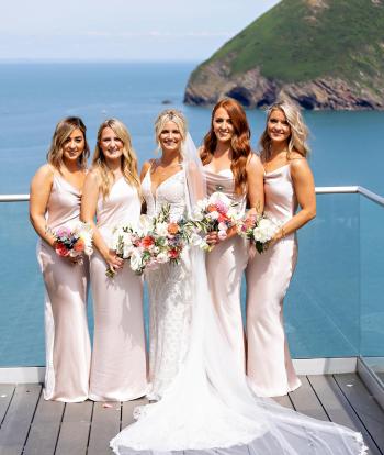 bride and bridesmaids with the view behind them