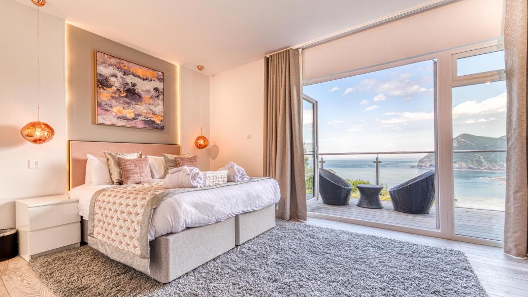 Room 43 at Sandy Cove Hotel featuring modern decor and a balcony with a view over the sea