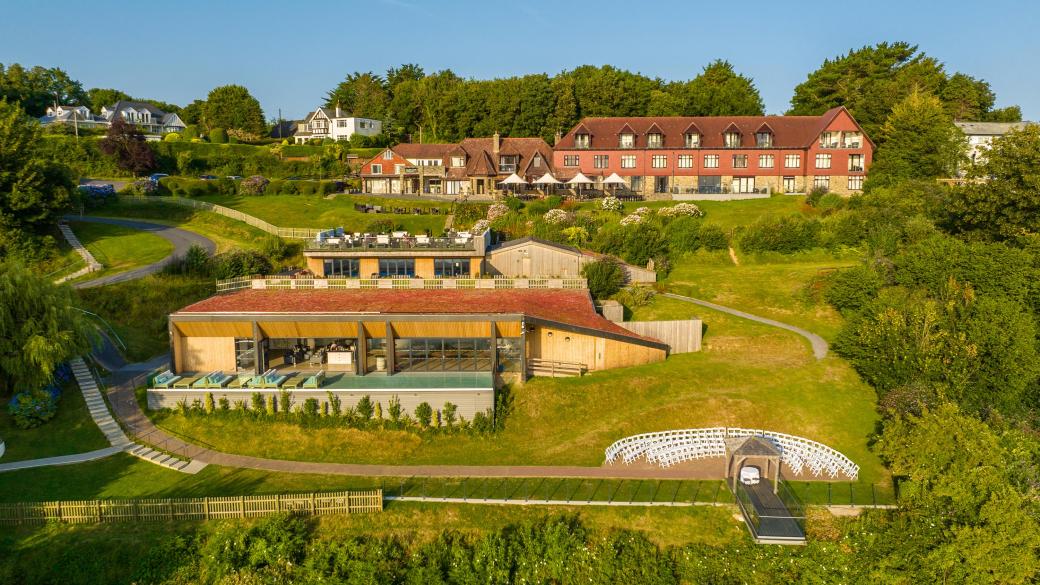 An aerial view of Sandy Cove Hotel in the late afternoon showing The Venue and outdoor wedding seating