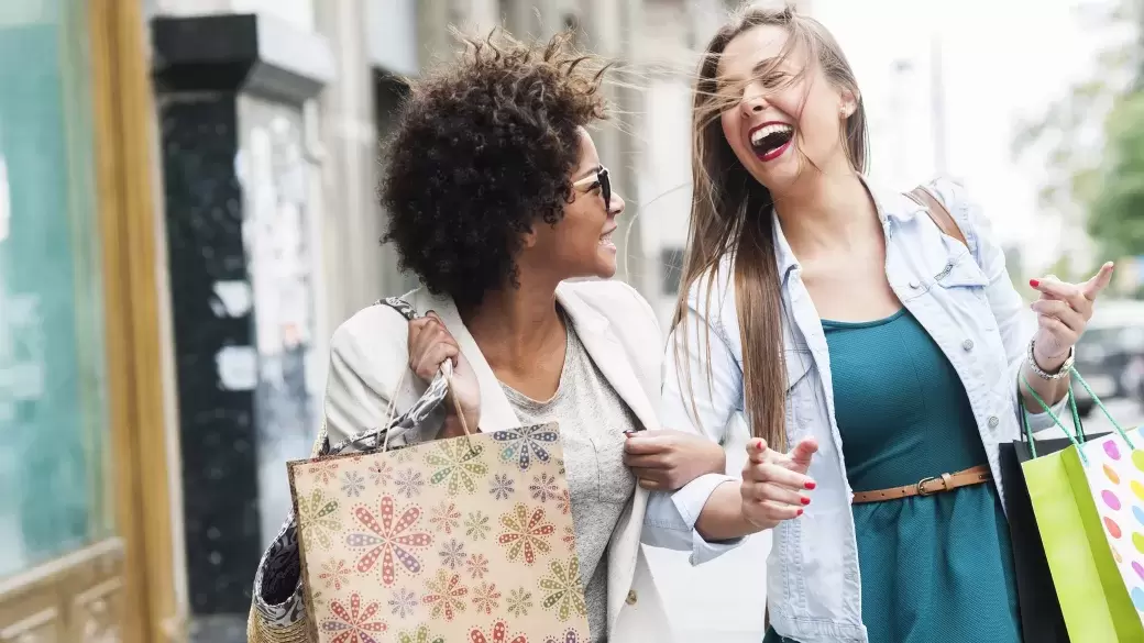 Two happy women with shopping bags