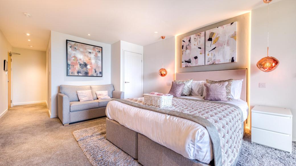 The interior of and executive sea view room with balcony at Sandy Cove Hotel showing the bed and seating area