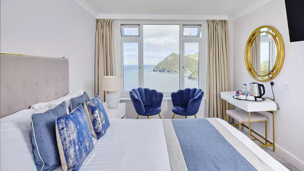 The interior of a classic room at Sandy Cove Hotel showing the view over the bay from the window