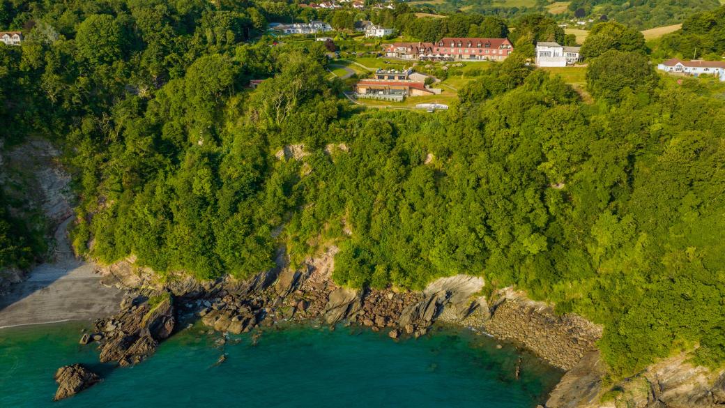 An aerial view of Sandy Cove Hotel and the surrounding countryside and sea