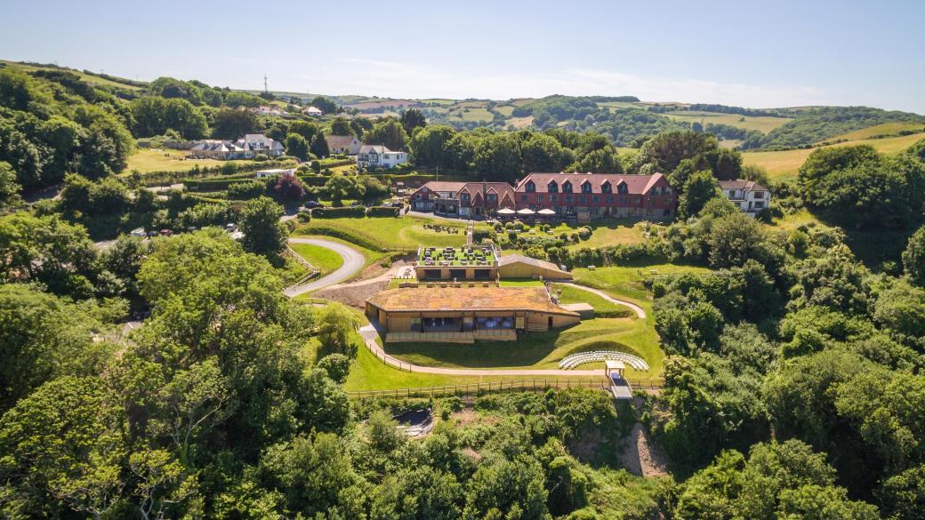 An exterior view of Sandy Cove Hotel and The Venue surrounded by North Devon countryside