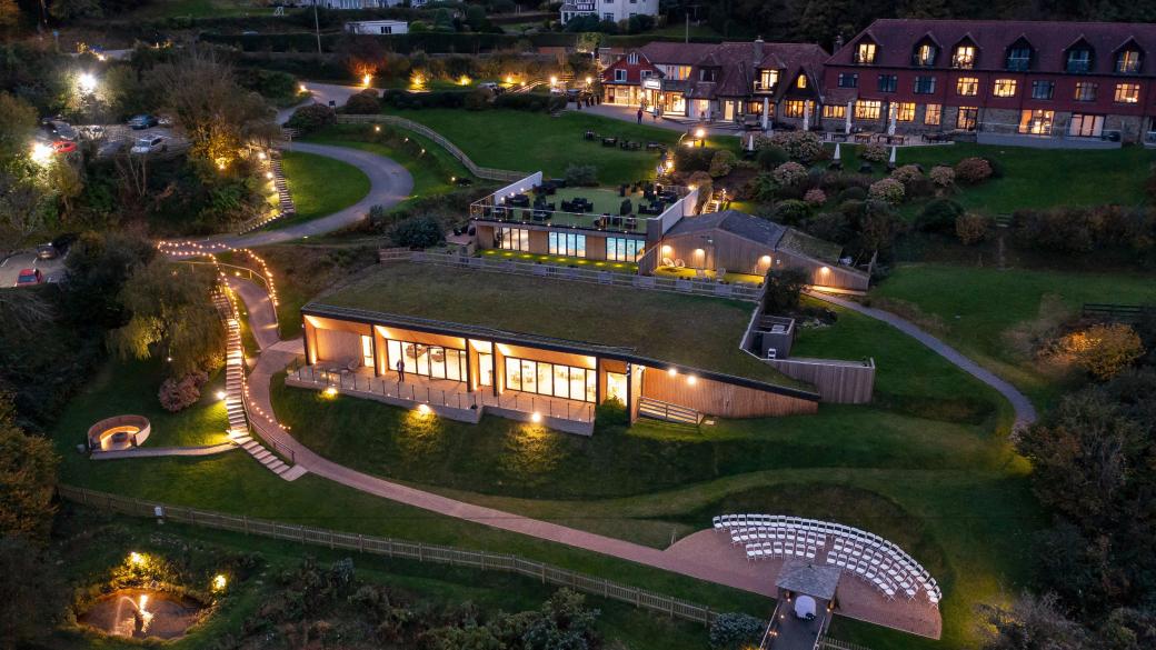 Sandy Cove Hotel and The Venue lit up with lamps after the sun has set