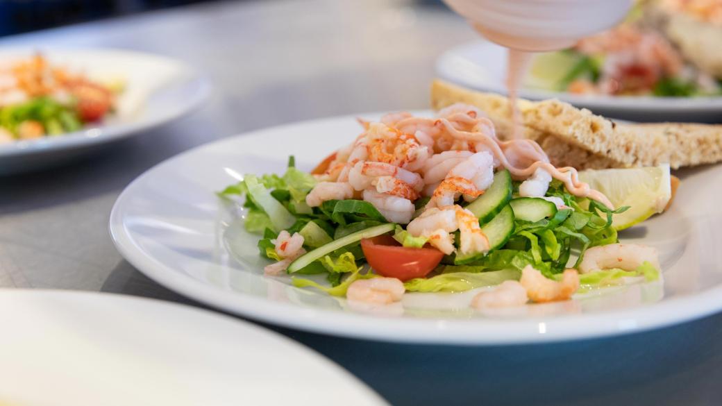 A chef preparing a prawn salad starter for a wedding at Sandy Cove Hotel