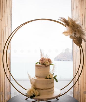 A wedding cake at the Venue, Sandy Cove, with a view over the bay behind