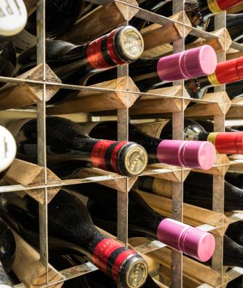 Bottles of wine in a rack behind the bar at Sandy Cove Hotel