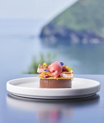 A dessert at the Sandy Cove Hotel with a view of the bay behind