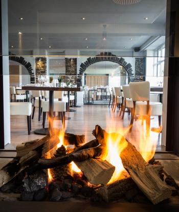 A view of the restaurant at Sandy Cove Hotel through the fireplace