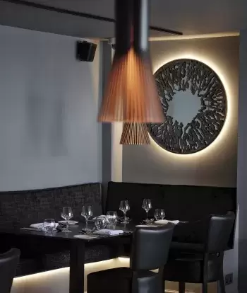 An interior view of the tables and decor in the Seacliff Restaurant at Sandy Cove Hotel