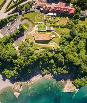 An aerial view over Sandy Cove Hotel showing the Terrace, The Venue and the coastline