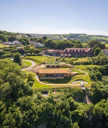 An exterior view of Sandy Cove Hotel and The Venue surrounded by North Devon countryside