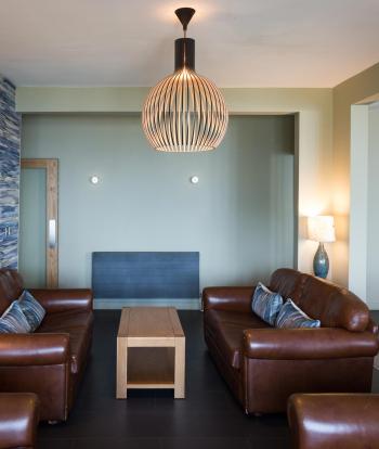 Brown leather sofas in Sandy Cove Hotels indoor lounge area