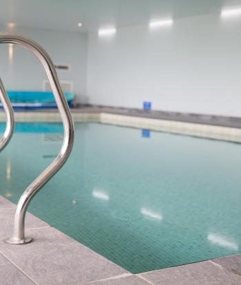 The steps and hand rails into the swimming pool at Sandy Cove Hotel