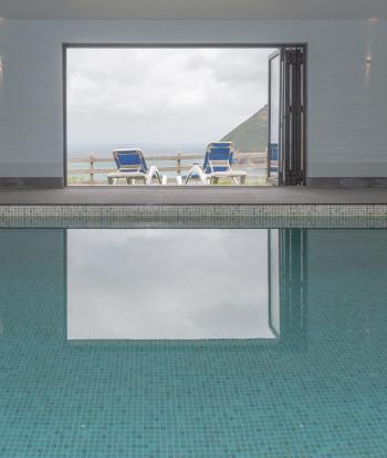 A view outdoors over the bay from the swimming pool at Sandy Cove Hotel