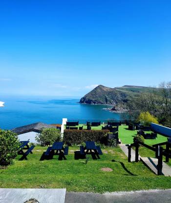 A view of the sea and countryside from Sandy Cove Hotel's outdoor terrace