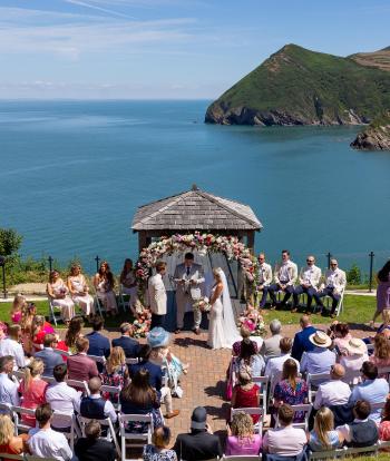 A wedding party gathered around the Gazebo at The Venue, Sandy Cove Hotel