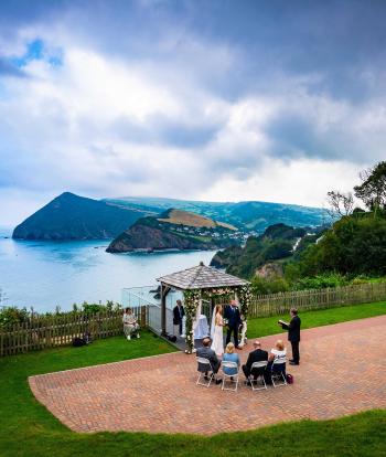 An intimate wedding under the Gazebo at The Venue, Sandy Cove Hotel, with a view of the bay in the background