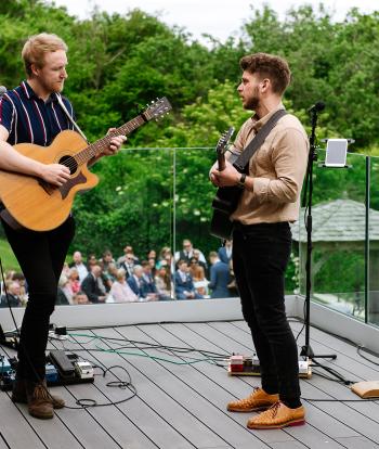 A wedding band playing to guests from the deck of The Venue at Sandy Cove Hotel