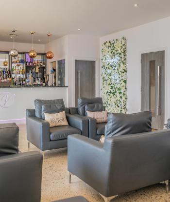 Armchairs in the bar area of the Venue at Sandy Cove Hotel