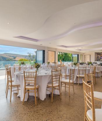 Inside The Venue at Sandy Cove Hotel with tables set up for a wedding reception