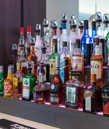 Bottles of drinks behind the bar in The Venue, Sandy Cove Hotel