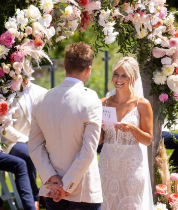 Wedding ceremony outside by the arbour with the view behind at the Sandy cove hotel