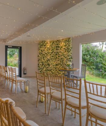 Chairs for guests and table for the couple inside the wedding Ceremony Room at Sandy Cove Hotel