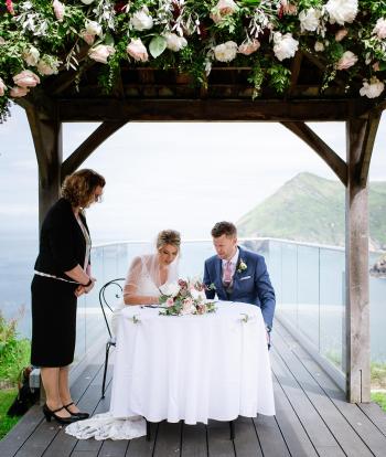 bride and groom signing paperwork