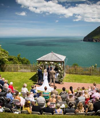 Bride and groom standing outside with beautiful view behind them