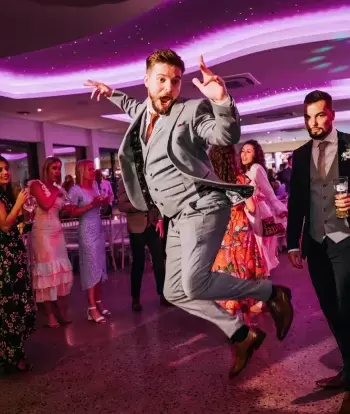 Wedding guests dancing in The Venue at Sandy Cove Hotel at an evening reception party