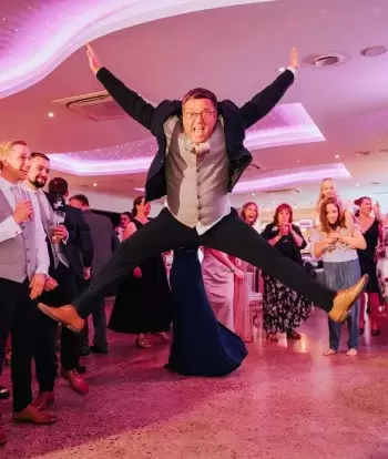 Wedding guests dancing in The Venue at Sandy Cove Hotel