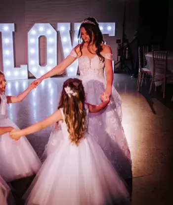 A bride dancing with her bridesmaids on her wedding day at The Venue, Sandy Cove Hotel