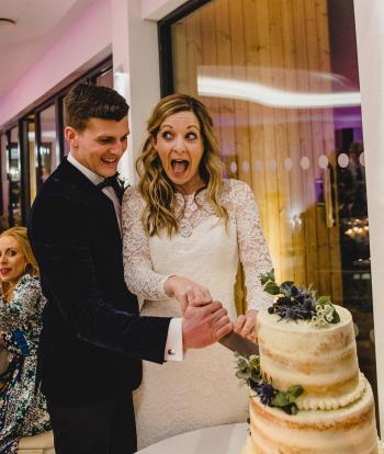 Bride and groom cutting the wedding cake