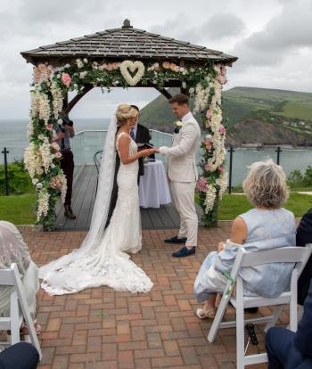 Bride and groom standing outside with beautiful view behind them