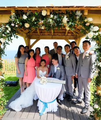 Wedding guests under the arbour at the Sandy Cove Hotel