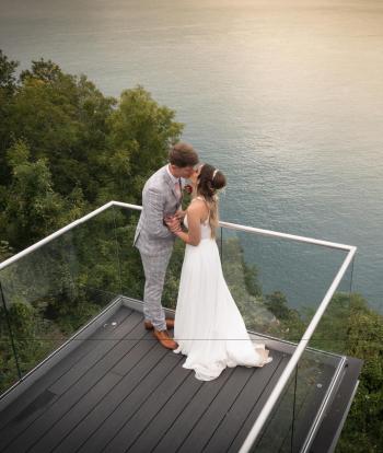 Bride and groom standing outside with beautiful view behind them