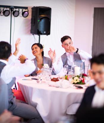 Bride and groom sat inside at table 