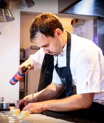 Chef preparing food for a wedding at the Sandy Cove Hotel, Devon