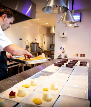 Chef preparing food for a wedding at the Sandy Cove Hotel, Devon