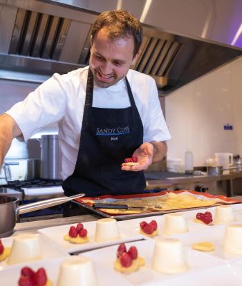 Chef preparing food for a wedding at the Sandy Cove Hotel, Devon