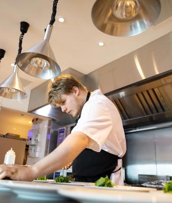 Chef preparing food for a wedding at the Sandy Cove Hotel, Devon