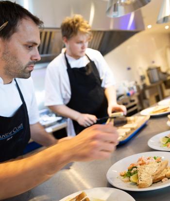 Chef preparing food for a wedding at the Sandy Cove Hotel, Devon