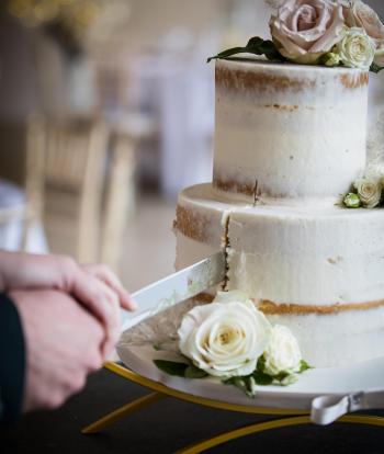 Wedding cake being cut at the Sandy Cove Hotel, Devon