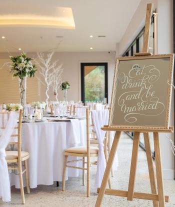 Wedding table and Easel set up at the Sandy Cove Hotel, Devon