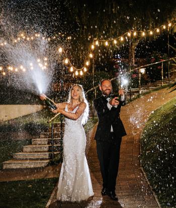 Bride & Groom Spraying Champagne