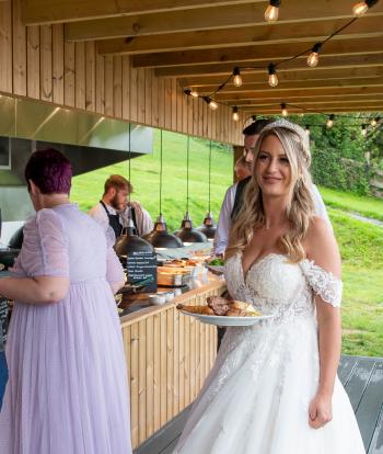 Bride getting her food at the barbecue