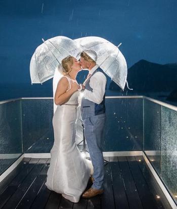 Night shot on Platform in rain with umbrellas