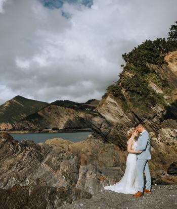 Wedding couple on beach with caves